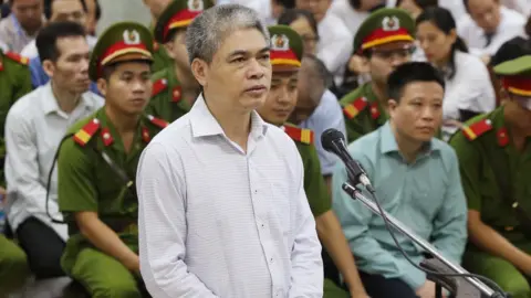 VIETNAM NEWS AGENCY/AFP Nguyen Xuan Son standing trial in Hanoi