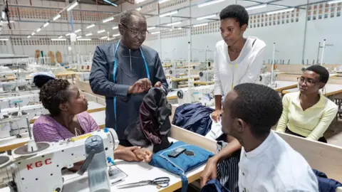 Jeroen van Loon Jerome Mugabo talking to staff at the Kigali Garment Centre