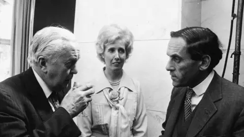 Getty Images British Prime Minister Harold Wilson (left), with his secretary Lady Falkender and Liberal Party leader Jeremy Thorpe, at a Variety Club Luncheon for Dame Vera Lynn, at the Savoy Hotel, London, July 23rd 1975.