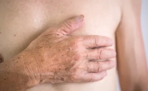 Getty Images Man clasping heart