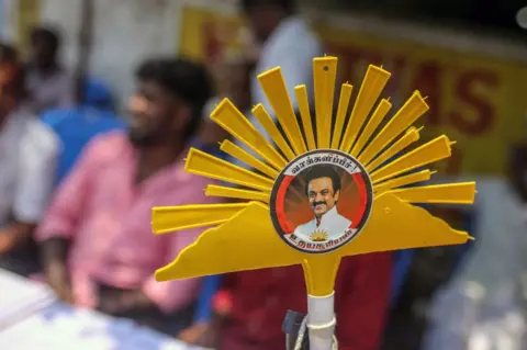 Getty Images A sign featuring the logo for the Dravida Munnetra Kazhagam (DMK) party near a polling station during the first phase of voting for national elections in Chennai, Tamil Nadu, India, on Friday, April 19, 2024.