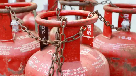 This photo from India's Kochi shows some red cooking gas cylinders chained together
