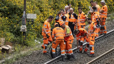 AFP Technicians of French railway company SNCF work to reconnect railway cables at the Mont-de-Terre train station in Lille, northern France on June 25, 2025.