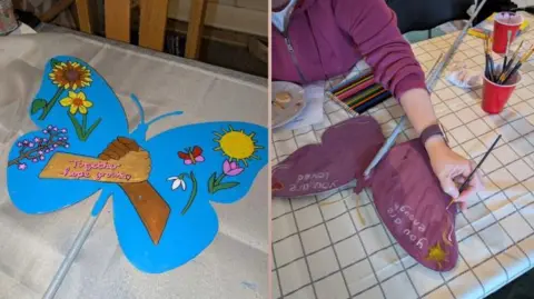 Jenni Swift A composite image of two photos next to each other. On the left is a painted butterfly cut-out with a light blue background, flowers and hands in the middle holding each other which reads 'together hope grows'. On the right is a dark pink painted butterfly with someone painting it and the words 'you are enough' written across it.