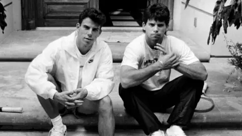 Erik and Lyle Fernandez sat in front of their family home in Beverly Hills, Los Angeles, in 1989