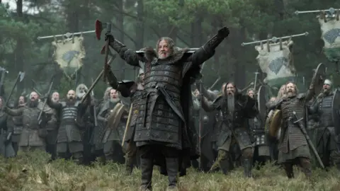 Theo Whiteman/HBO An army gets ready to fight in armour 