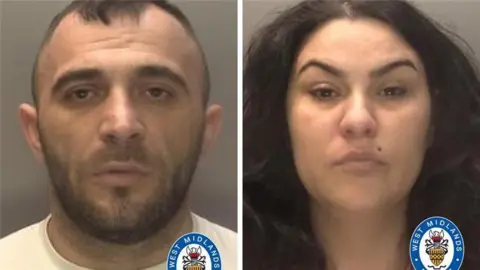 A composite of two mugshots side by side. On the left is a man with very short dark hair and a stubbly beard. He is wearing a white shirts. On the right is a woman with long, thick black hair and a mole over her lip.
