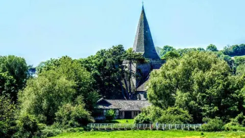 Andy Chapman A building surrounded by trees