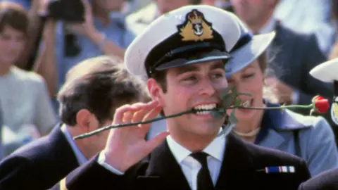 Getty Images Prince Andrew in 1981, returning from the Falklands War, with a rose between his teeth