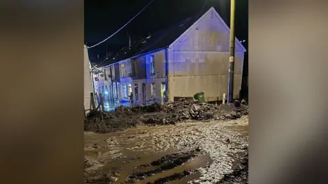 Jack Humphrey A picture showing mud strewn across a street