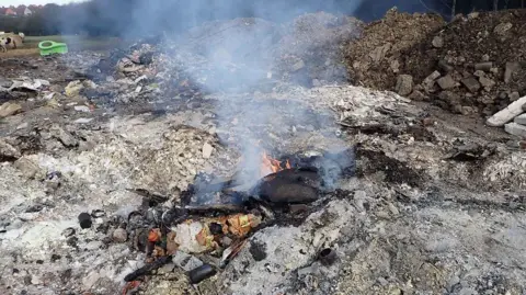 Environment Agency  A small fire burning at the site