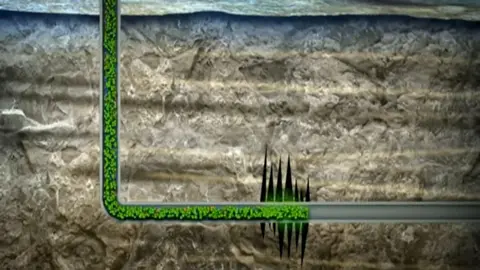 A diagram of a pipe going into the ground containing fluid. The pipe enters rock and cracks are shown in the rock where the fluid is being pumped in.