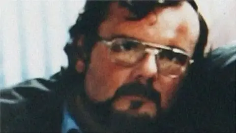 Pacemaker Seamus Ruddy, a 32-year-old man who is wearing glasses. He has dark hair covering his forehead and has a beard and moustache. 