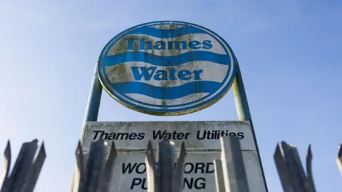 A Thames Water sign covered in green mildew