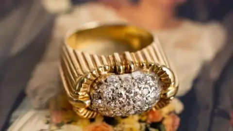 Bearnes Hampton & Littlewood An 18ct gold diamond ring, which features a domed white centrepiece including 27 single-cut diamonds of slightly varying sizes.