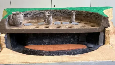 Albion Archaeology/Central Bedfordshire Council A reconstruction of the kiln, with four vessels on top.