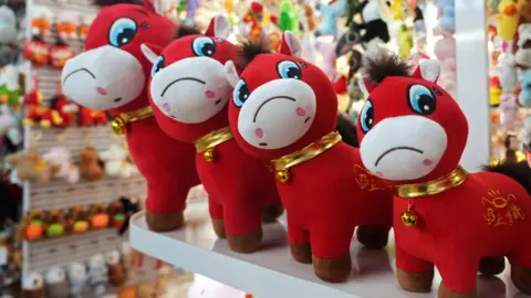 Crying horse plush toys sit on display ahead of the Chinese Lunar New Year, which will welcome the Year of the Horse, at Yiwu International Trade City in Yiwu, Zhejiang province, China.