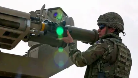 Soldier putting missile in tube
