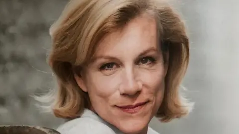 Courtesy of Stratford Literary Festival A close-up photo of a woman in front of a plain grey background. She has blonde hair and is wearing a cream top.