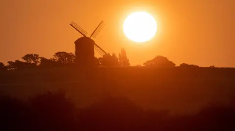 The sun rises over Chesterton Windmill in Chesterton, Warwickshire