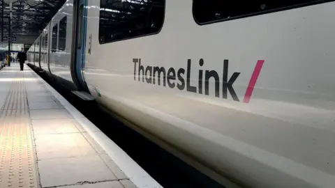 Jonathan Brady/PA Wire The side of a white ThamesLink train at a platform Kings Cross station in London