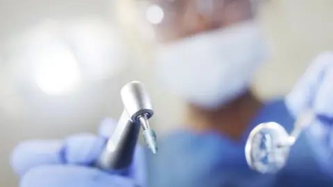 Getty Dentist with tools