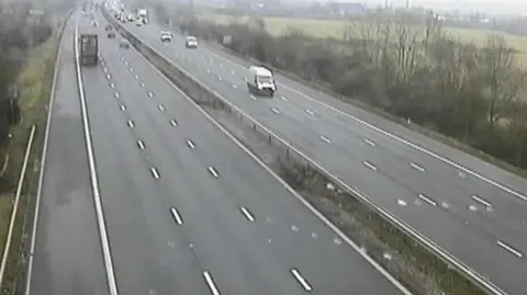 National Highways A screenshot from a grainy traffic camera on the M4. It shows completely cleared lanes and traffic running smoothly.