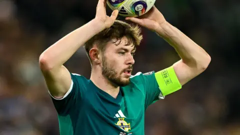 Conor Bradley takes a throw in