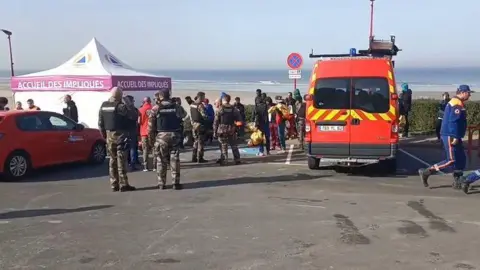 BBC Emergency services at the car park of Saint-Etienne-au-Mont beach with a tent and ambulance