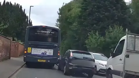 Warwickshire Police A dark blue ford crashed into the back of a bus and a white car