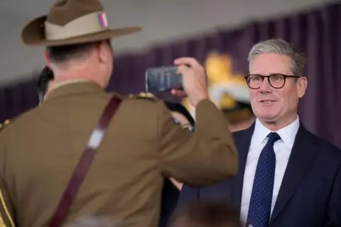 Andrew Matthews/PA Media Labour leader Sir Keir Starmer poses for a photo