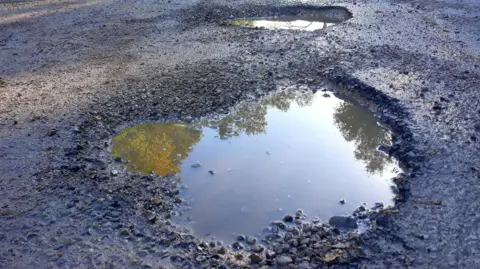 Getty Images A pothole on an asphalt road