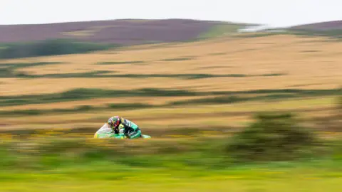 CLASSICTT A rider on a classic bike riding at speed over a section of the Mountain course.