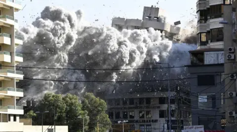 A big black cloud of smoke rises following an Israeli airstrike on the Al-Chiyah area of Dahieh district, south of Beirut, Lebanon, 22 November 2024