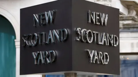 PA Media File image of the silver and grey New Scotland Yard three-sided sign