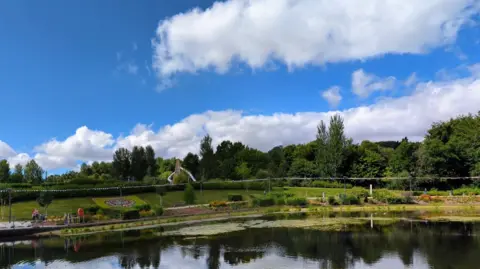 Google A google street view image of a park with lots of trees and greenery overlooking a river