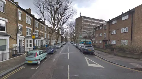 Google Street view image of East Street with terrace houses and cars parked.