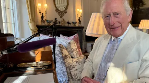 The King with his script for the BBC World Service broadcast