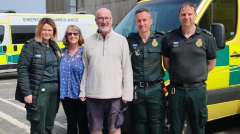 Graeme Martin (centre), with his partner Lori (second from left) meeting paramedics 