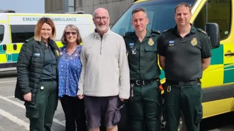 South East Coast Ambulance Service Graeme Martin (centre), with his partner Lori (second from left) meeting paramedics 