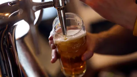 Getty Images A Foster's pint glass is being filled from a pub draught tap
