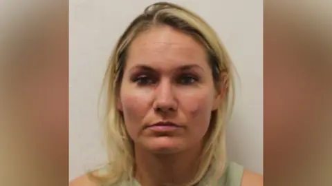 A custody image of a blonde woman.