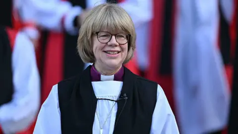 The new Archbishop of Canterbury Sarah Mullally smiles on the steps of St Paul's Cathedral after taking part in a 'Confirmation of Election' ceremony in London