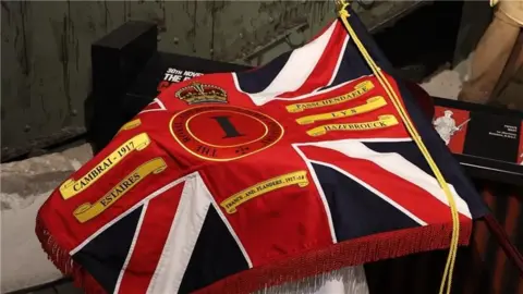 States of Guernsey A military standard which included the union jack flag a crown and gold scrolls. 