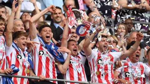 Corry Evans lifts the League One play-off trophy