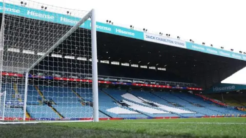 Getty Images A view of an empty Elland Road from the pitch. Lots of blue and white seats can be seen. 
