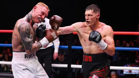Chris Billam-Smith and Ryan Rozicki trade blows in the ring 