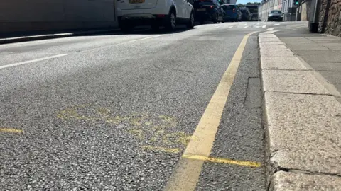 Rouge Bouillon in St Helier. The road has yellow markings on it.
