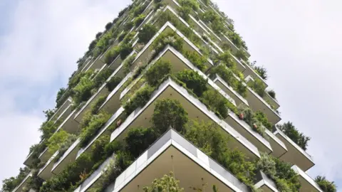 Sandwell Council Planning Portal A vertical tower with balconies and lots of plants. It is high in the sky against a blue sky background with some clouds. CGI image. 