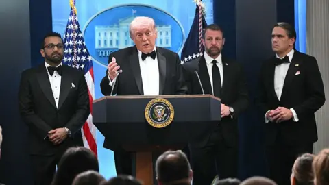 Mandel Ngan via Getty Images US President Donald Trump wearing a black tuxedo speaks at the White House briefing room